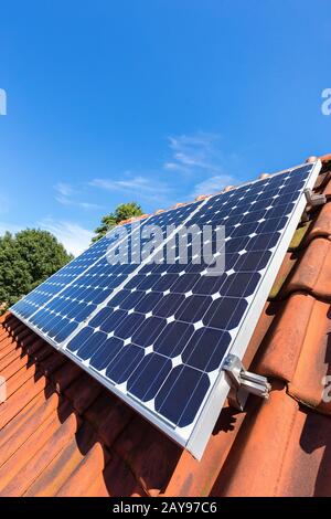 Blue solar panels  in a row on roof of house Stock Photo