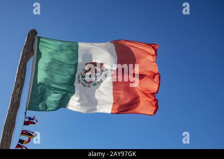 Mexican flag in the blue sky Stock Photo