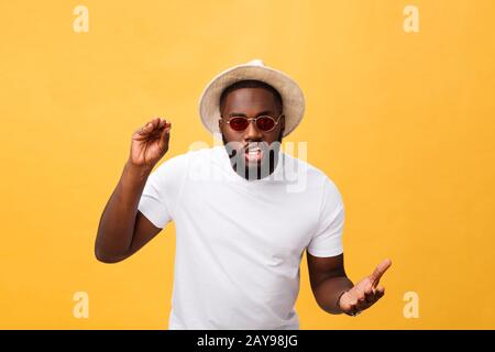 Young african american man wearing white t-shirt shouting and screaming loud to side with hand on mouth. Communication concept. Stock Photo