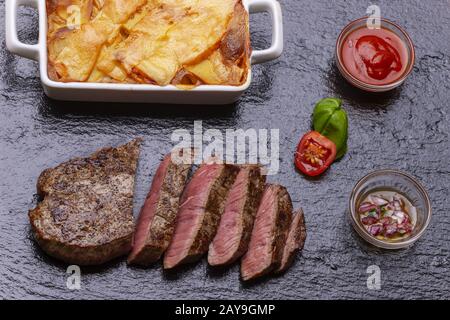 Steak in slices with potato gratin Stock Photo