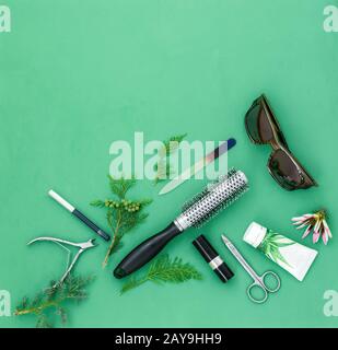 Cosmetics items on a light green background. Stock Photo