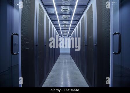 Server room full of racks and servers Stock Photo