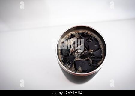 A thermos of iced coffee and ice cubes shot from above. Stock Photo