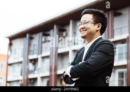 Portrait of a smiling handsome businessman with arms folded Stock Photo