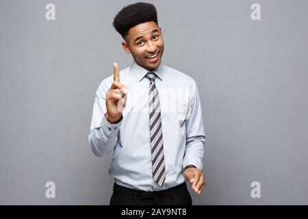 Business Concept - portrait of African American holding two peace or two fingers sign. Stock Photo