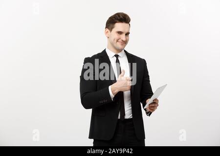 business, communication, modern technology and office concept - smiling buisnessman with tablet computer showing thumbs up. Isol Stock Photo