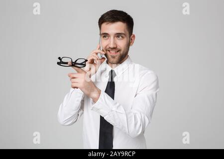 Lifestyle and Business Concept - Portrait of a handsome businessman enjoy talking with mobile phone. Isolated White background. Stock Photo