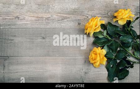 Luxury yellow roses on a background of light wood Stock Photo