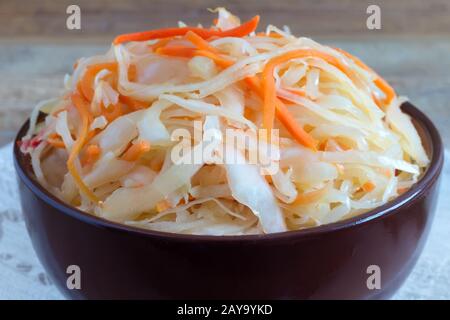 Sauerkraut with carrots in a ceramic Cup. Stock Photo