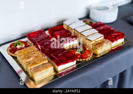 Selection of fruit cake slices with strawberry, kiwi, jelly and apple Stock Photo
