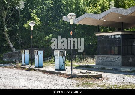 Old abandoned vintage obsolete petrol fuel gas dispensers in former neglected petrol station Stock Photo