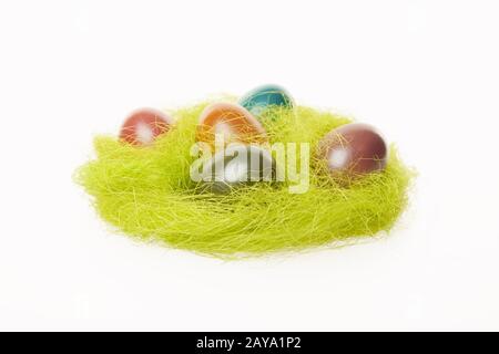 Easter nest with colorful eggs isolated on white background Stock Photo