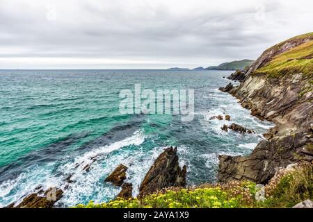 Scenic coastline and waves crashing on rocks Stock Photo