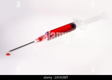 Syringe with blood on white background Stock Photo