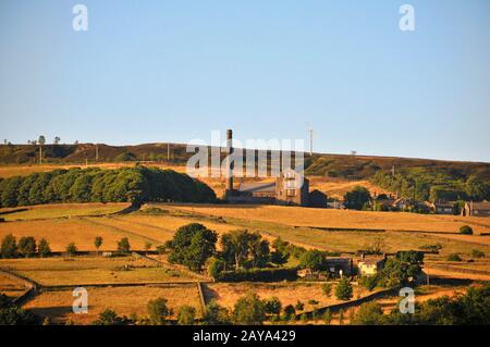 old town near hebden bridge in west yorkshire with summer sunshine on farms and old mill buildings Stock Photo