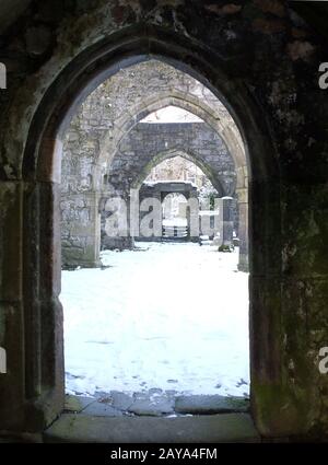 arches in doorways of a ruined medieval church in the snow in heptonstall west yorkshire Stock Photo