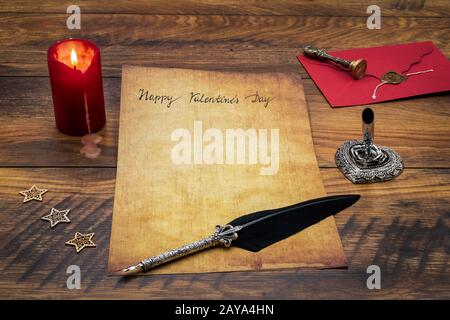 Happy Valentines Day card with red envelope, candle and quill Stock Photo