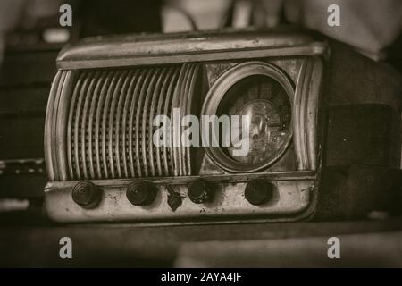 Old vintage radio receiver of the last century with rustic clock build in Stock Photo