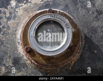 old rusty circular temperature gauge mounted on industrial machinery Stock Photo