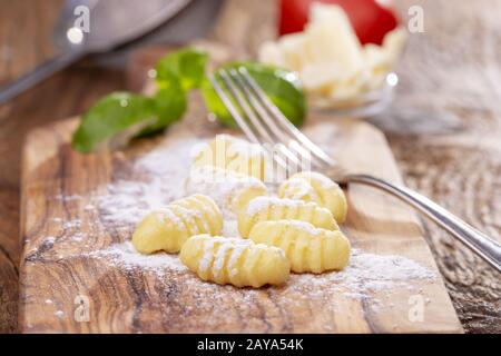 Close-up of raw gnocchi on wood Stock Photo