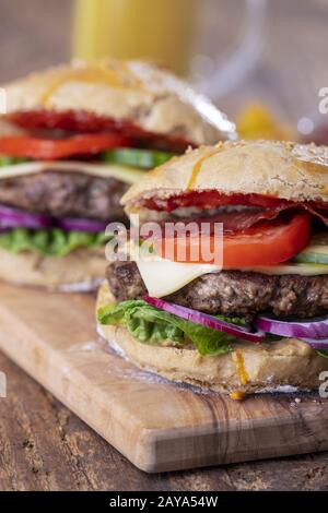 homemade burgers on dark wood Stock Photo