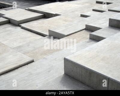 grey modern geometric cubic concrete steps forming angular patterns and shapes Stock Photo