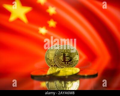 Bitcoin gold coin and defocused flag of China background. Virtual cryptocurrency concept. Stock Photo
