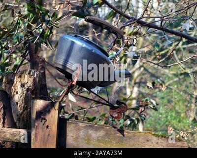 old discarded kettle on top of a gate post in a rural setting Stock Photo