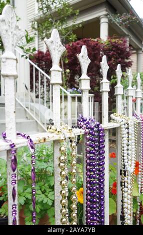 Mardi Gras beads on a fence in New Orleans Stock Photo