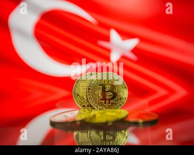 Bitcoin gold coin and defocused flag of Turkey background. Virtual cryptocurrency concept. Stock Photo