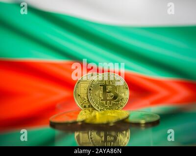 Bitcoin gold coin and defocused flag of Bulgaria background. Virtual cryptocurrency concept. Stock Photo