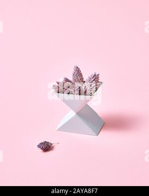 Creative composition of two cardboard boxes with cones on a pink background with space for text. Autumn layout Stock Photo
