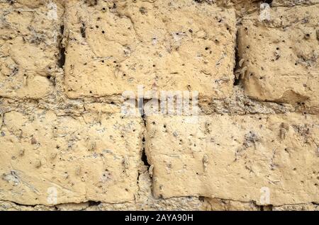 old yellow mud brick wall background Stock Photo