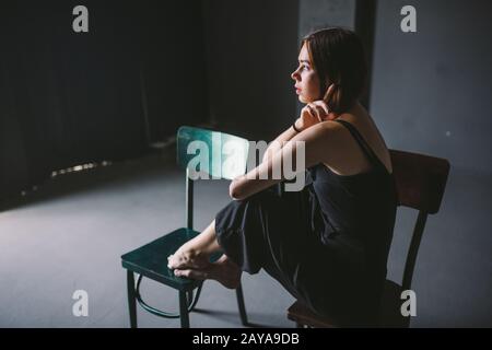 The social theme female loneliness pain suffering. Abastration male violence family. A young beautiful Caucasian woman in black Stock Photo