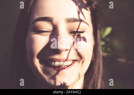 Young woman closeup face portrait in the woods Stock Photo