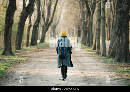 Young woman walking on an avenue on her travel journey. Stock Photo