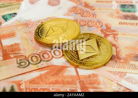 Close-up of Ethereum coins on 5000 Russian rubles banknote. Crypto currency ETC. Stock Photo