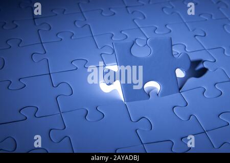 Blue jigsaw puzzle. Business solutions, solving problems,science technology and team building concept. Stock Photo