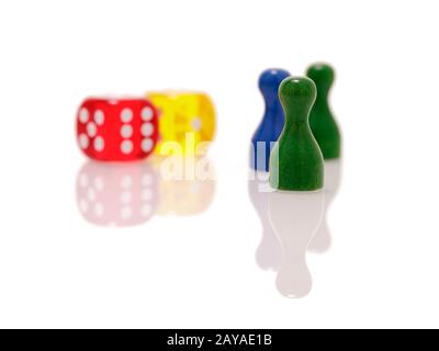 Gambling dices and wooden figures isolated on white background. Games, entertainment and luck concept. Stock Photo