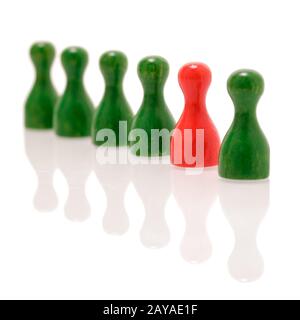 Row of wooden green figures and one red figure. Teamwork Stock Photo