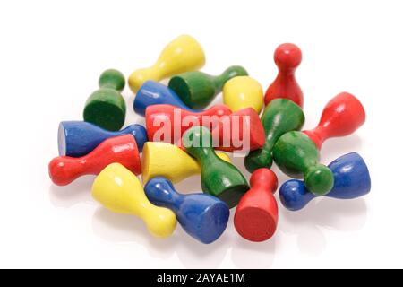 A heap of colorful wooden game figures isolated on white background. Gaming toys, society and teamwork concept. Stock Photo