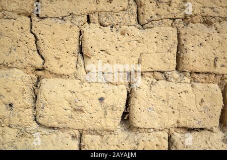 old yellow mud brick wall background Stock Photo