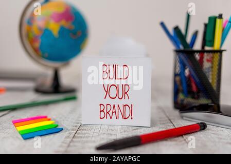 Text sign showing Build Your Brand. Conceptual photo creates or improves customers knowledge and opinions of product Stationary Stock Photo