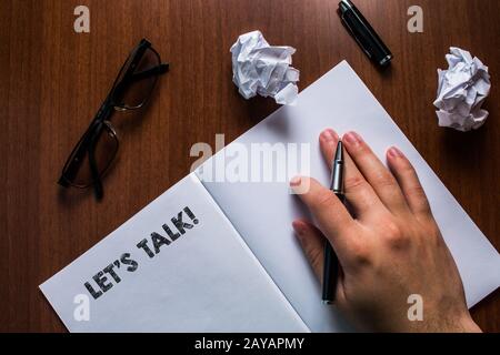 Writing note showing Let S Talk. Business photo showcasing they are suggesting beginning conversation on specific topic Man hand Stock Photo