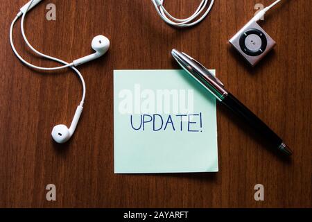 Handwriting text writing UPDATE. Concept meaning make something more modern or up to date like software program Upper view earph Stock Photo