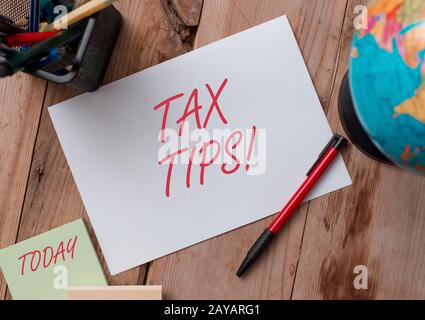Word writing text Tax Tips. Business concept for compulsory contribution to state revenue levied by government Writing equipment Stock Photo