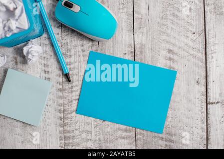 Crumpled paper and computer mouse with stationary placed above wooden table. Empty cardboard plus modern tool stick classic back Stock Photo