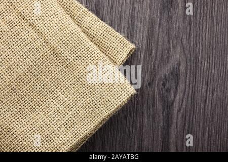 Front view wooden background blank textile, jute, linen, tag, piece isolated on colored timber back. Abstract design. Back timbe Stock Photo