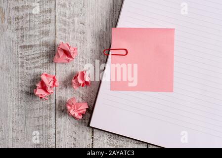 Thick pages notebook stationary on the top of a wooden table. Writing equipment placed above classic look backdrop. Artistic way Stock Photo