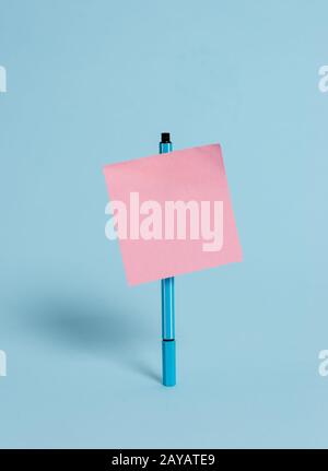 Standing ballpoint blank colored sticky note peaceful cool pastel background. Empty text future important events. Abstract desig Stock Photo